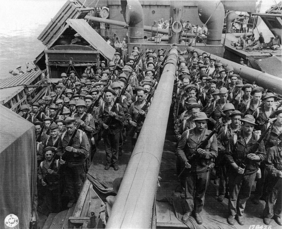 Soldiers of the 127TH Infantry, 32D Division doing a rifle inspection aboard the USS George Taylor enroute from Brisbane, Australia to Port Moresby, New Guinea, on 18 Nov. 1942.