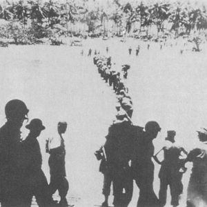 Soldiers carrying ammunition and supplies to the beach on Morotai ca. September 1944.